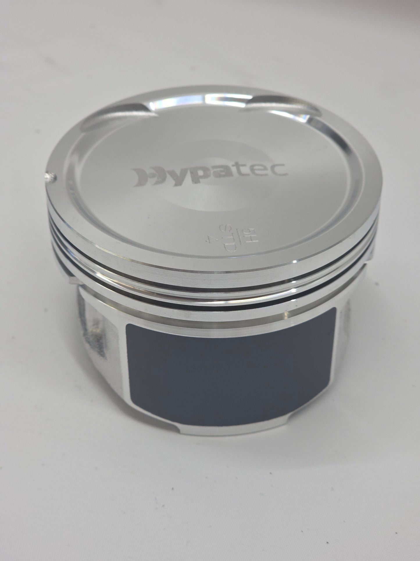 close up of metal piston head with white background