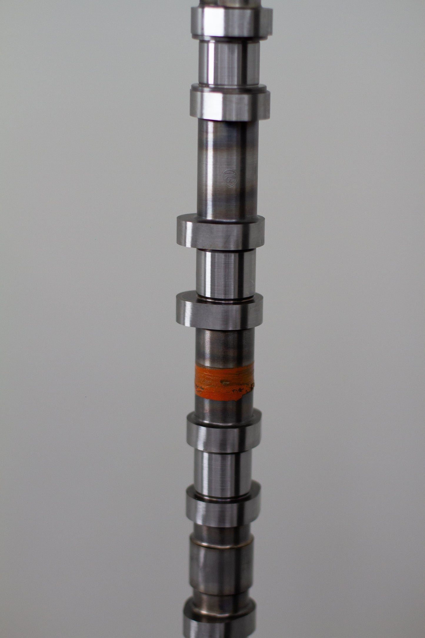 Metal camshaft on a gray background