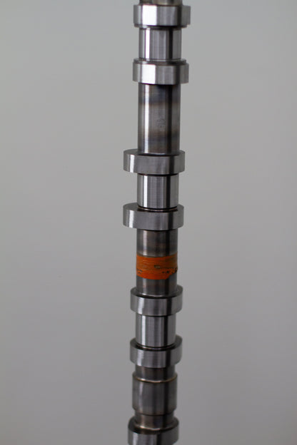 Metal camshaft on a gray background