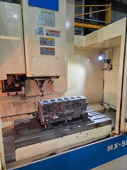 cast engine block being machined