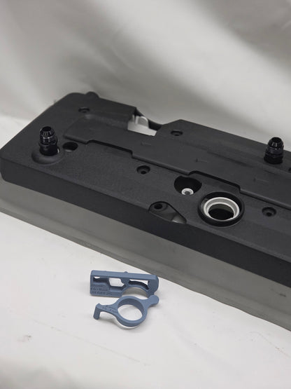 engine rocker cover with plastic cover with black weld on orbs and 3d printed fitting jig with a white background