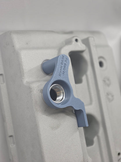 close up of weld on orb with 3d printed fitting jig on engine rocker cover with white background