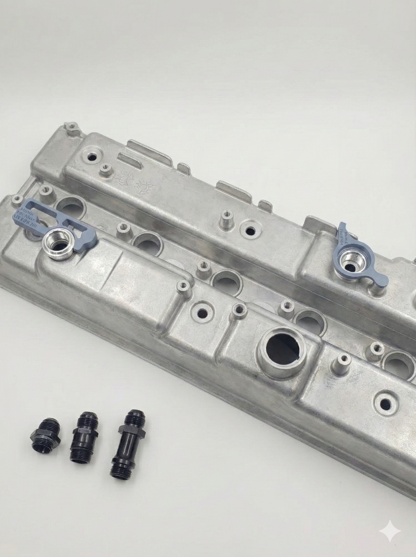 engine rocker cover with weld on fitting kit on a white background