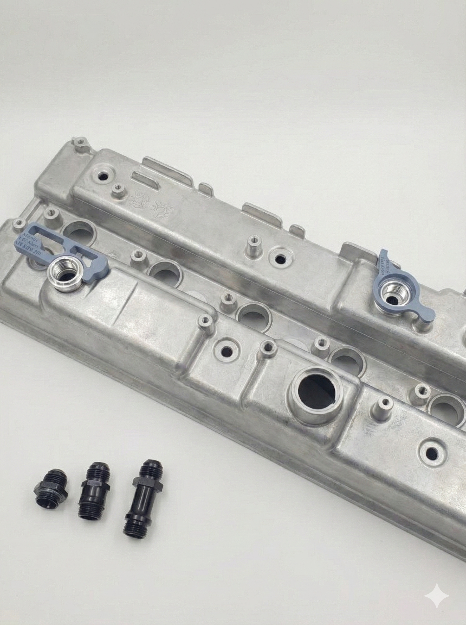 engine rocker cover with weld on fitting kit on a white background