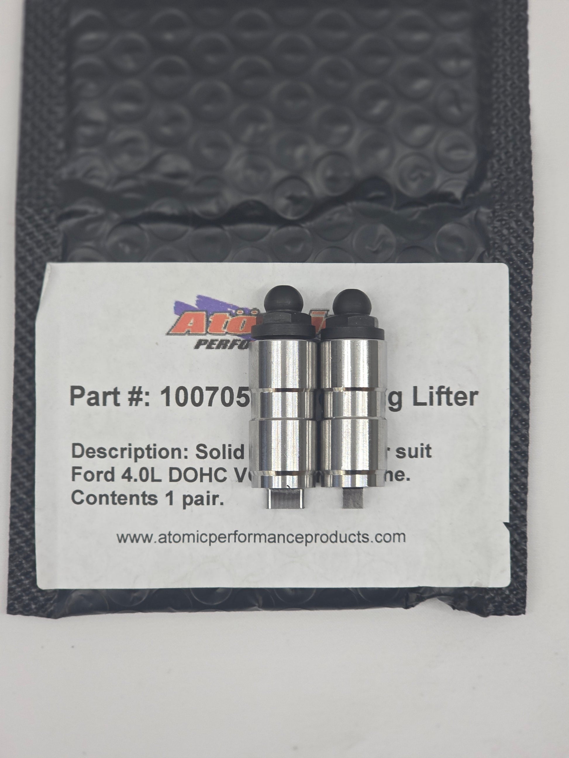 silver and black solid checking lifter on black bubble mailer with label