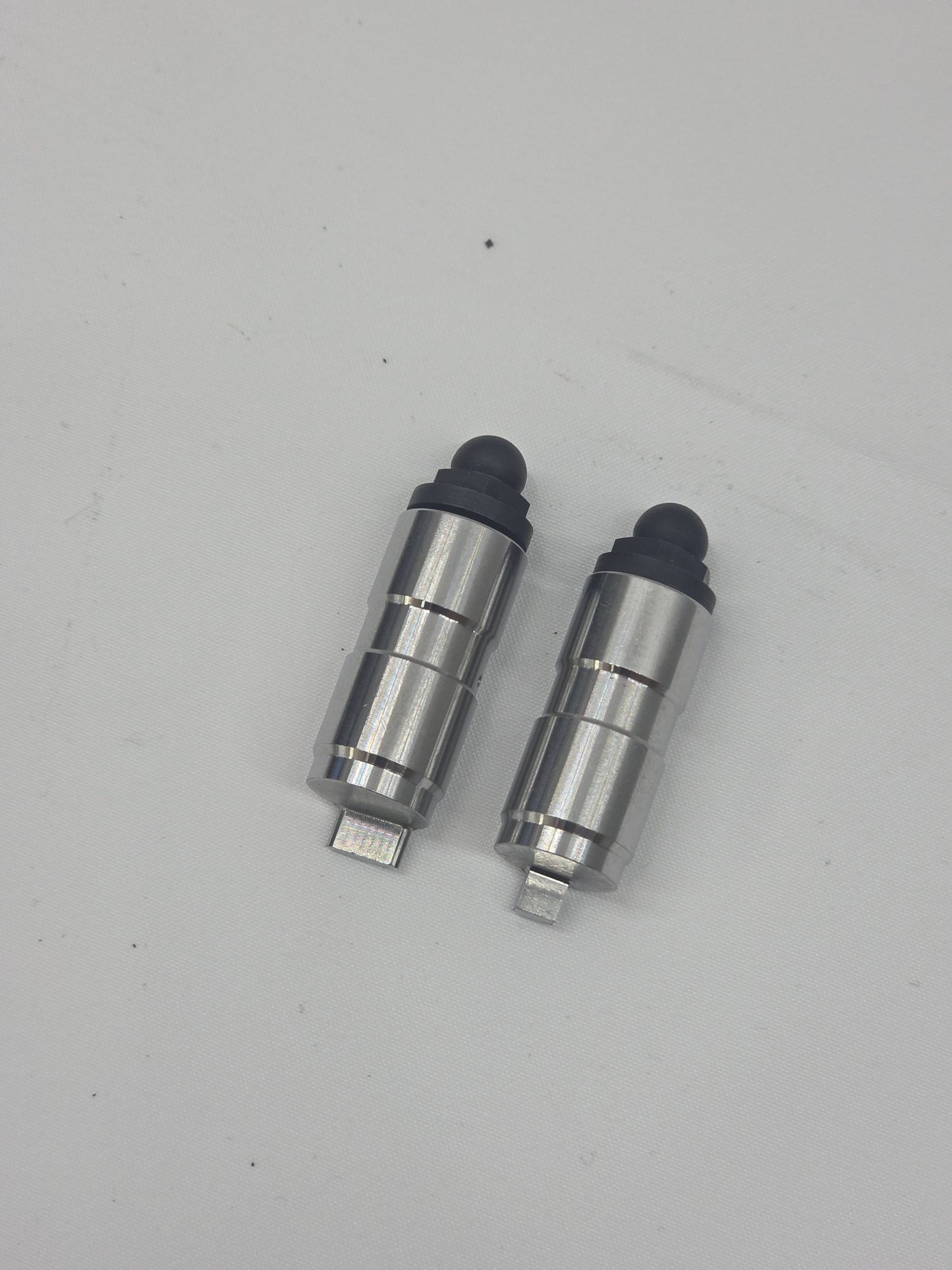 silver and black engine checking lifter on white background