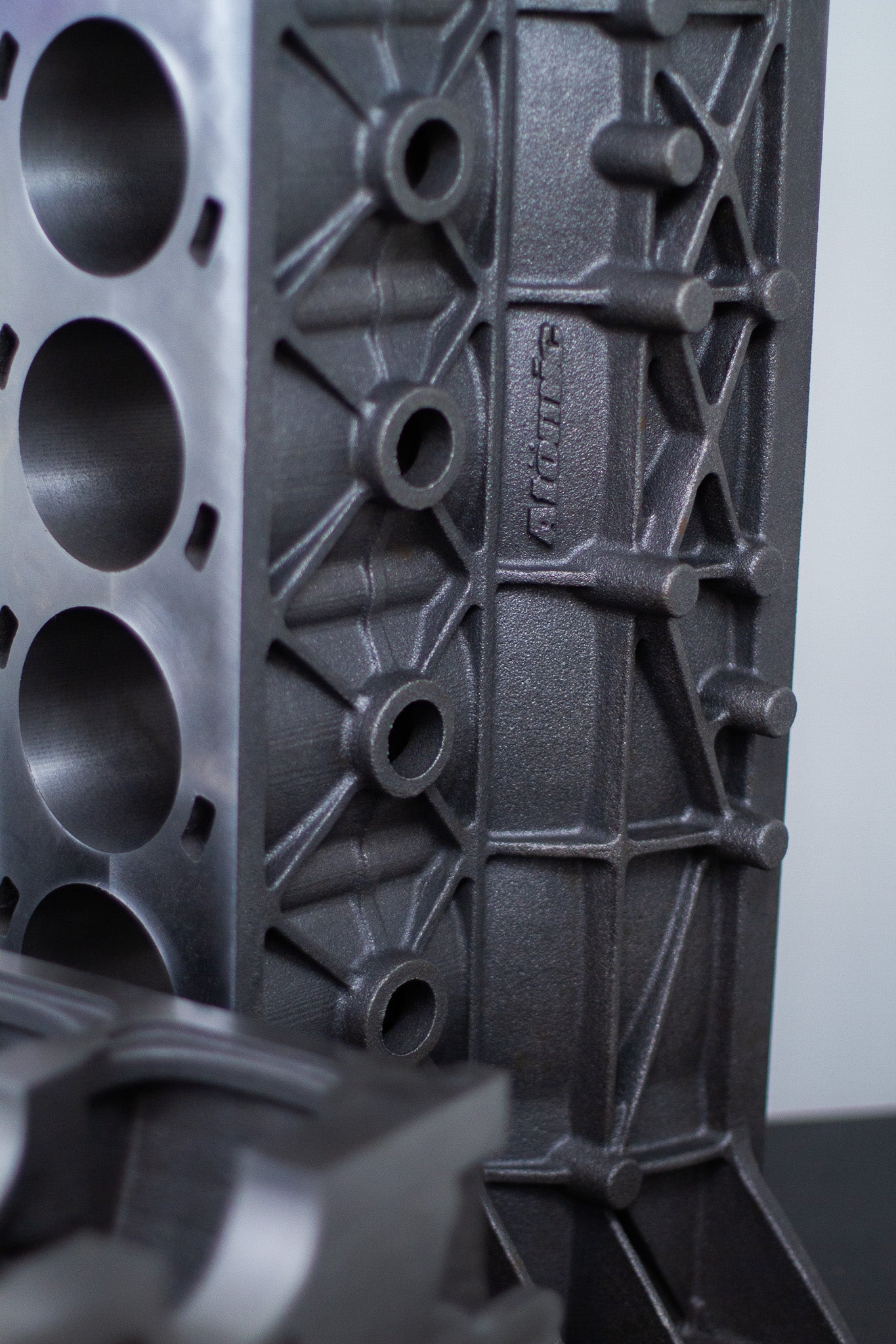 gray upright cast engine block with white background