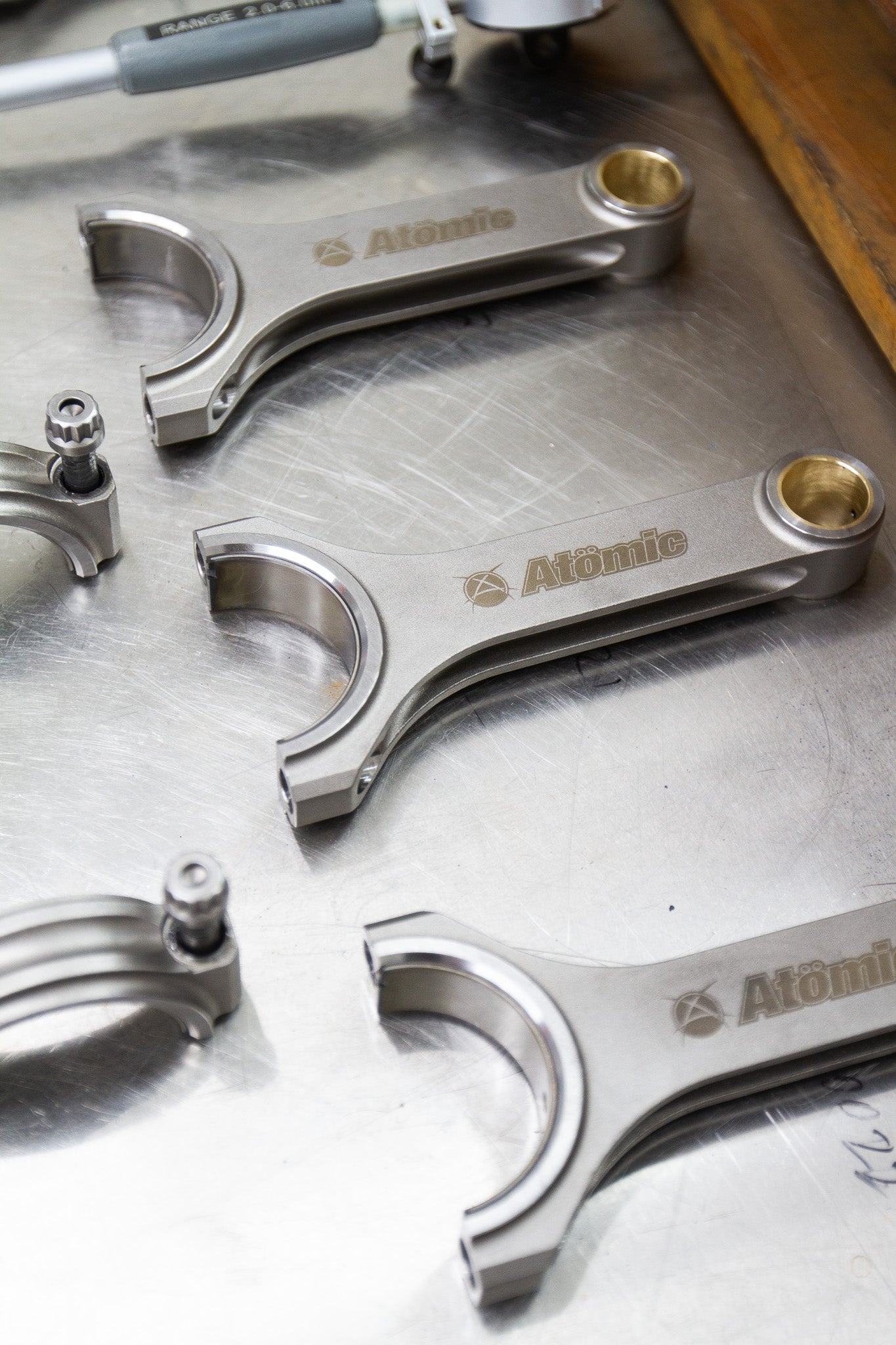 metal connecting rods on a steel/silver background