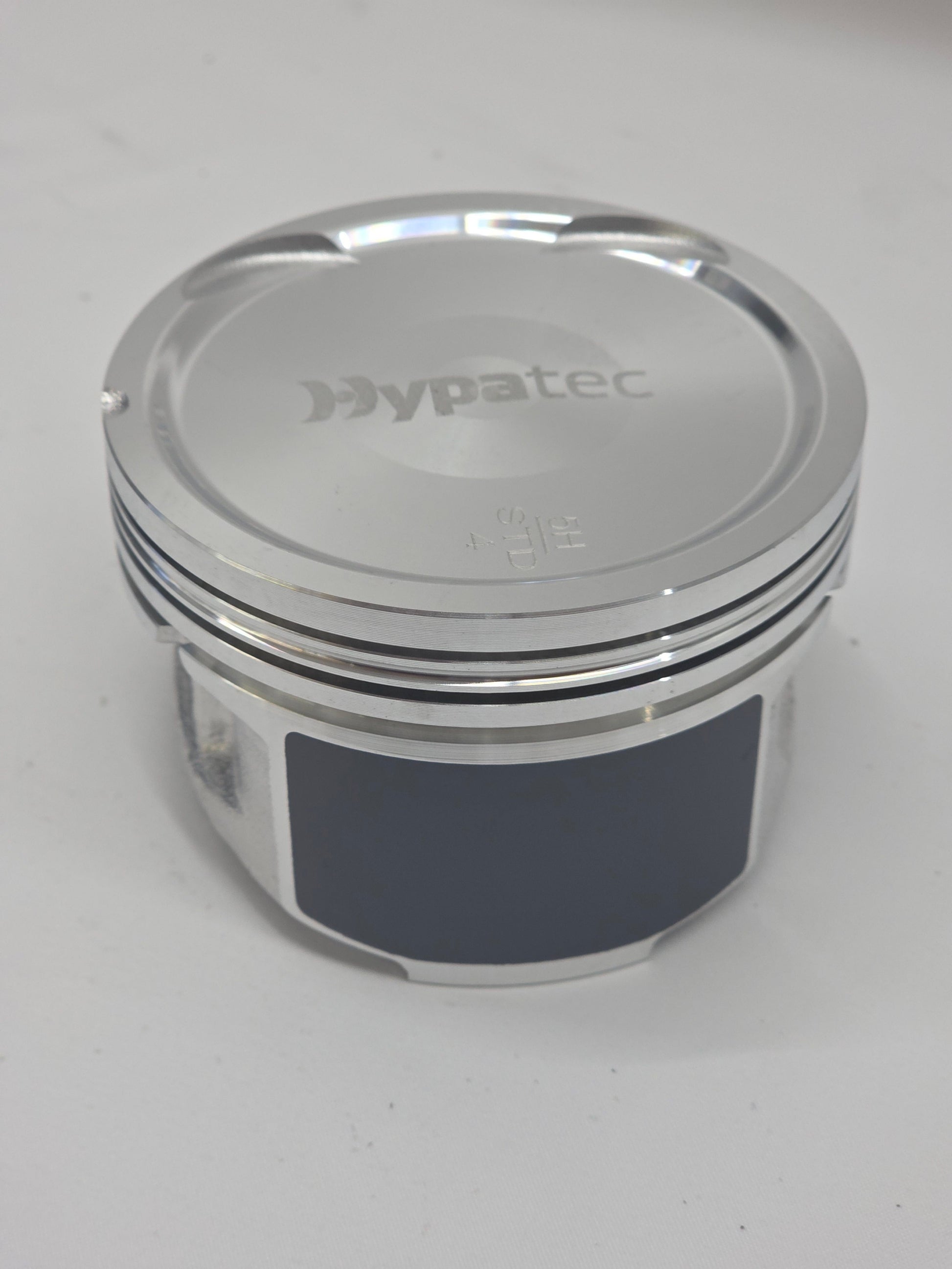 close up of metal piston head with white background