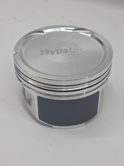 close up of metal piston head with white background