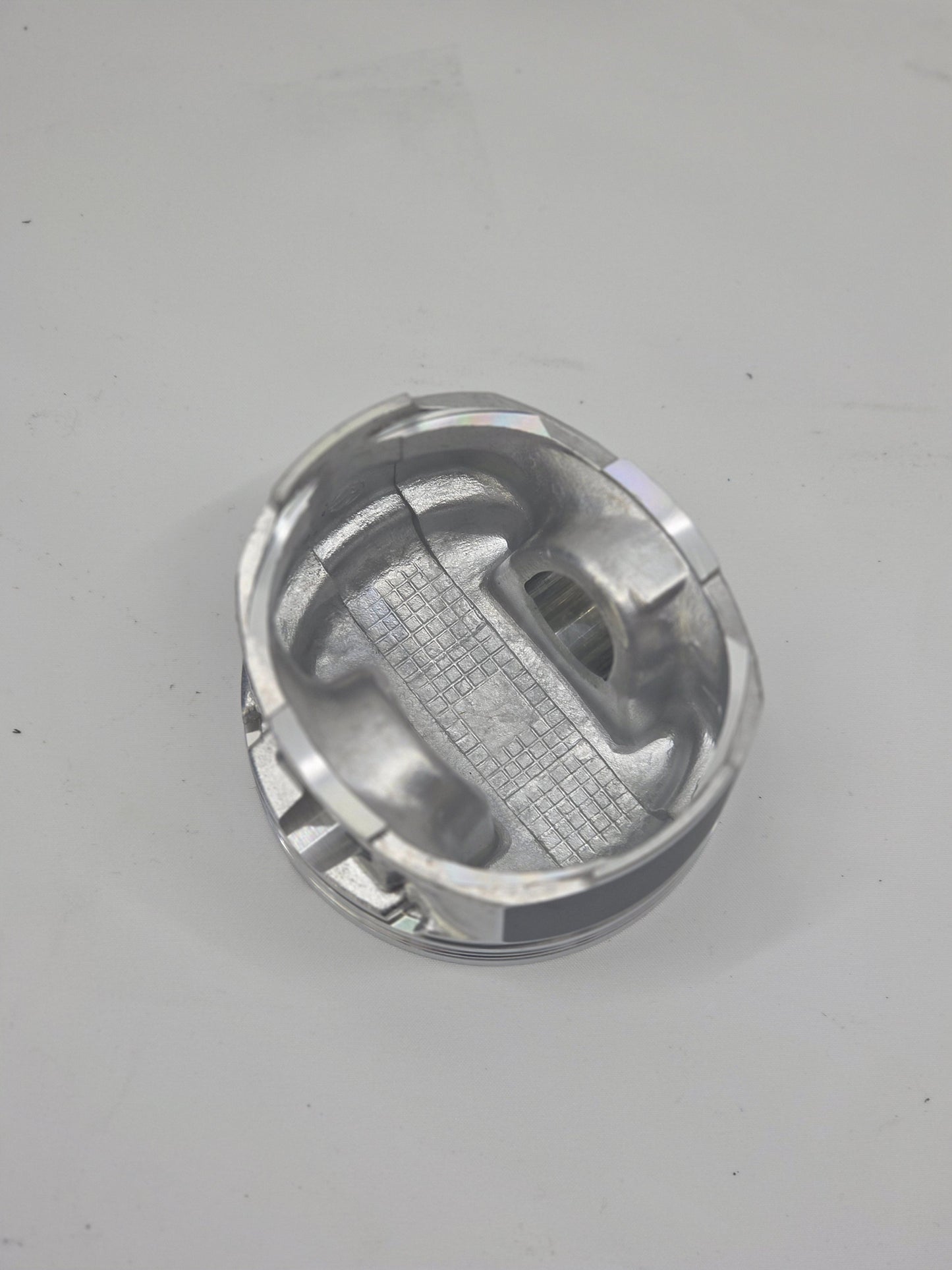 close up of internal side of  cast engine piston head on white background 