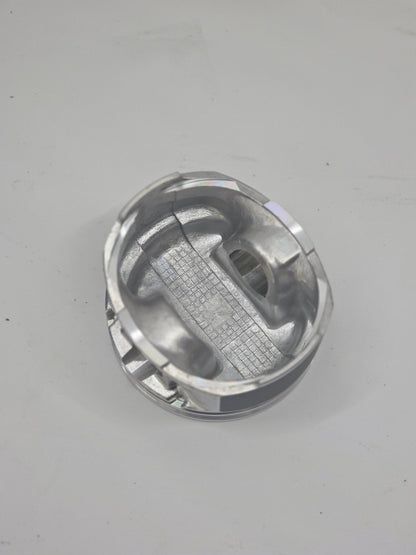close up of internal side of  cast engine piston head on white background 