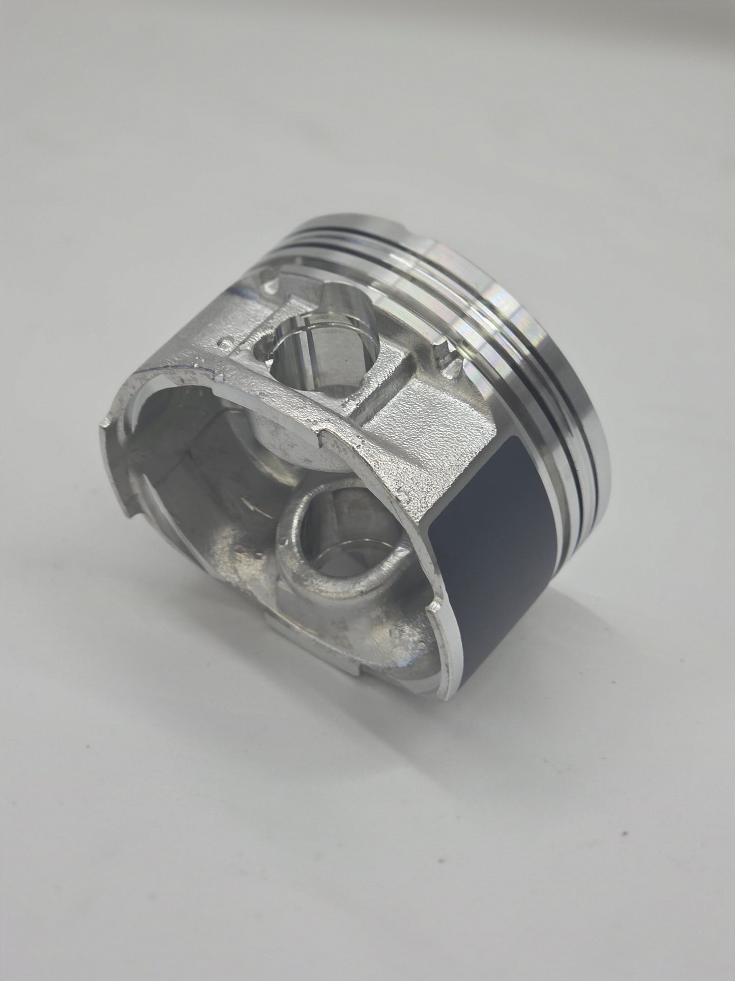 Metallic piston on a light gray background
