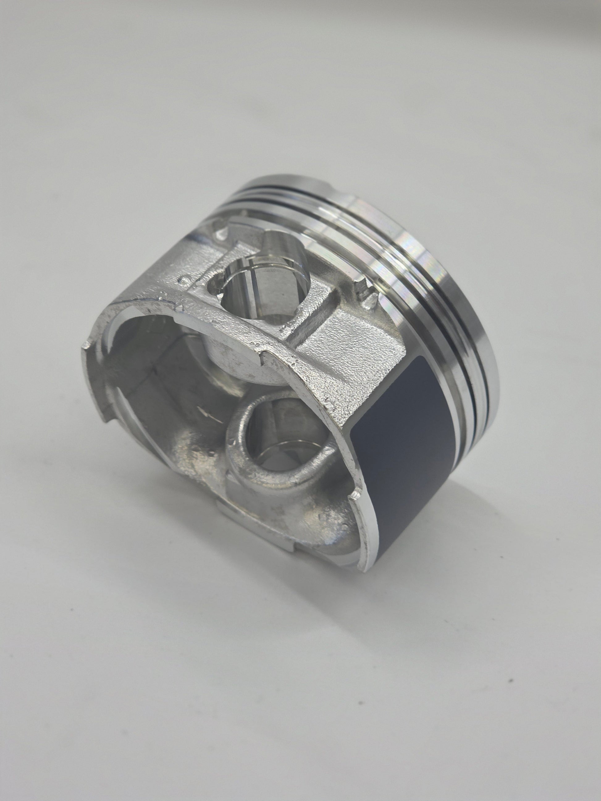 Metallic piston on a light gray background